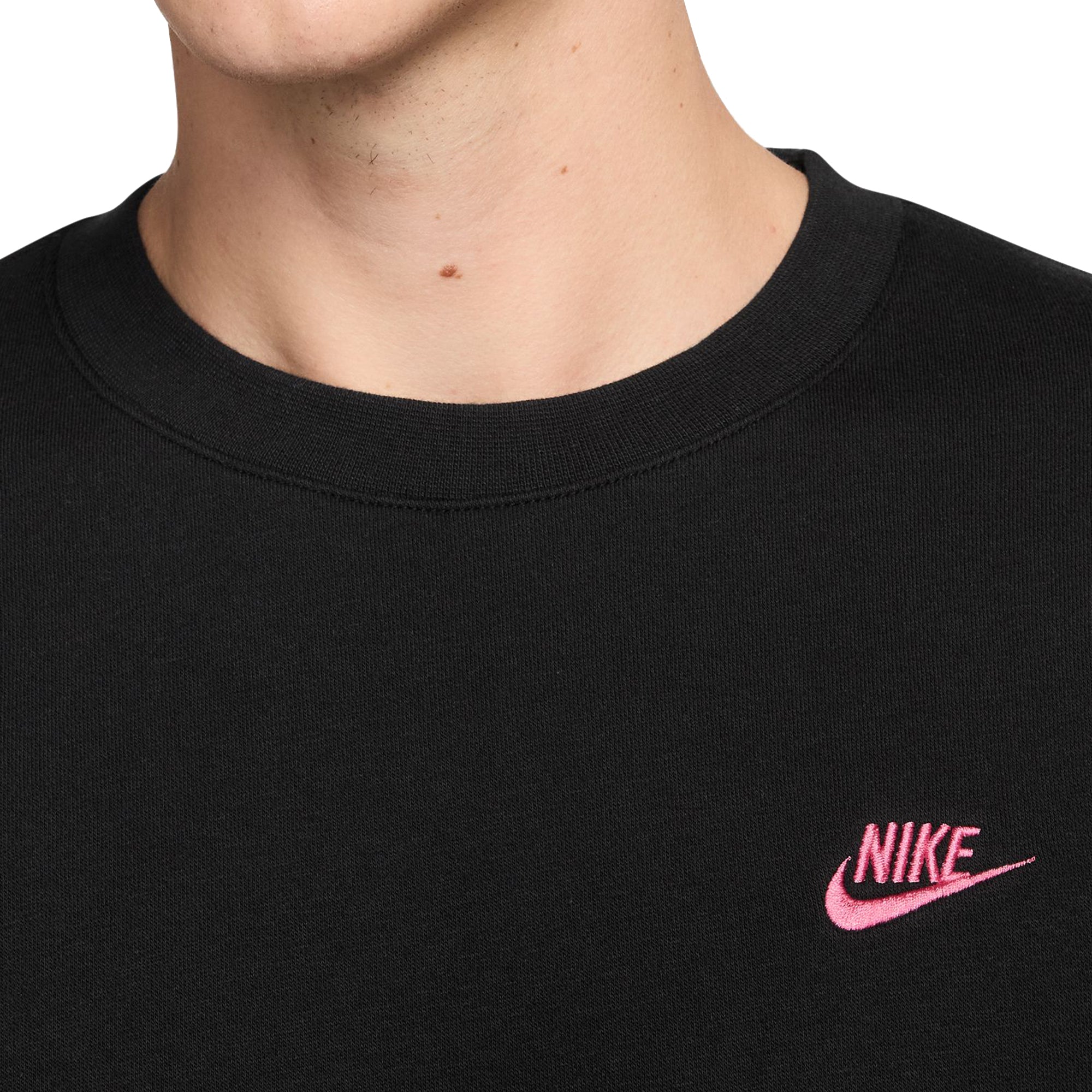 black nike shirt with pink swoosh