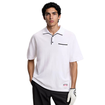 Man wearing a white polo shirt with black accents and a golf glove on a white background