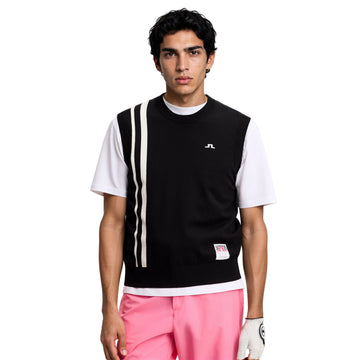 Man wearing a black and white sleeveless shirt with pink pants on a white background