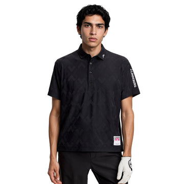 Man wearing a black patterned polo shirt with a brand logo on a white background